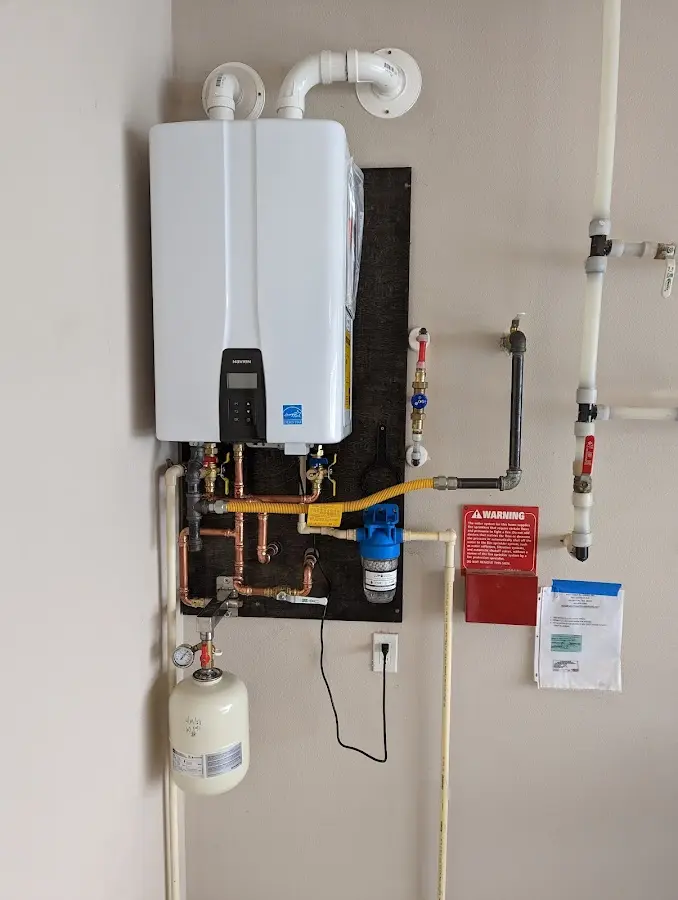 Professional plumber installing copper piping in a Tifton home
